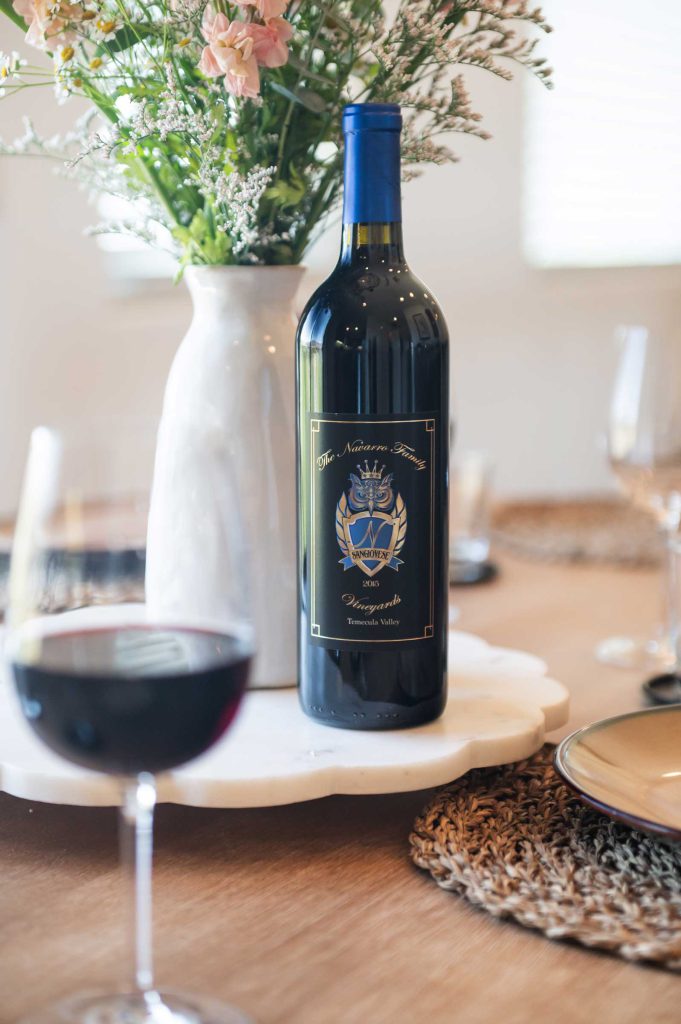 bottle of Navarro Family Vineyards Sangiovese on a table beside a full glass