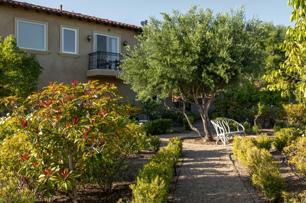 exterior with lush garden and trees of Villa de Portola at Navarro Family Vineyards